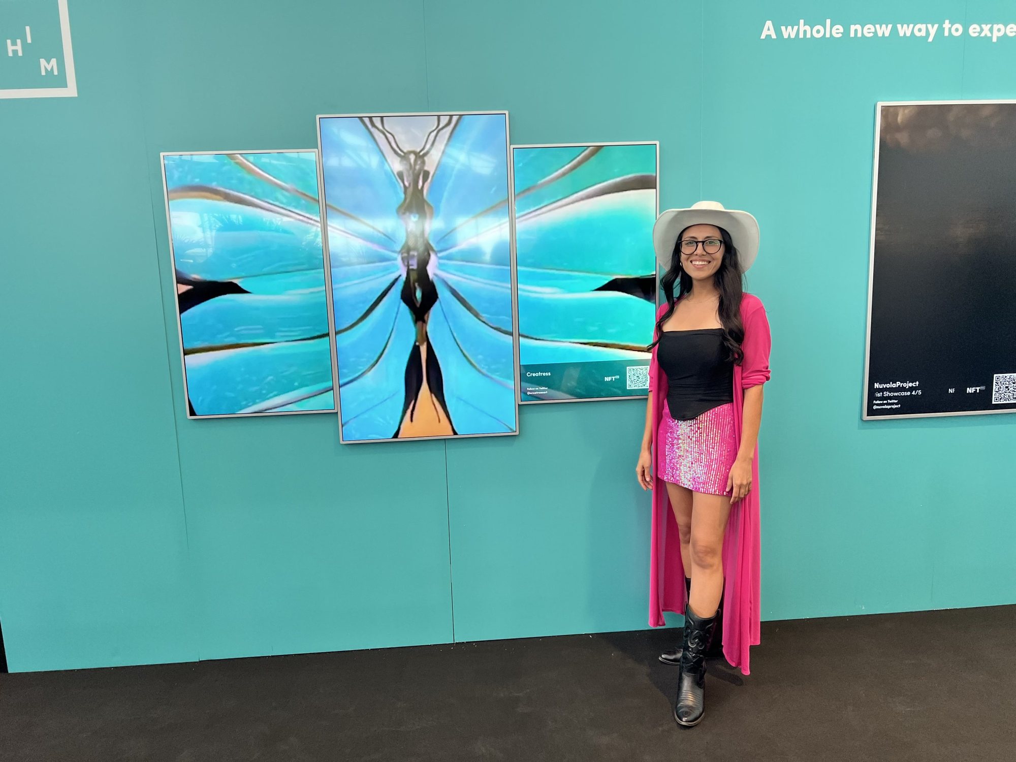 Three screens showing a butterfly sculpture, the artist standing beside them